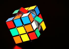 A close-up of a colorful Rubik's Cube puzzle, showcasing concentration and play.